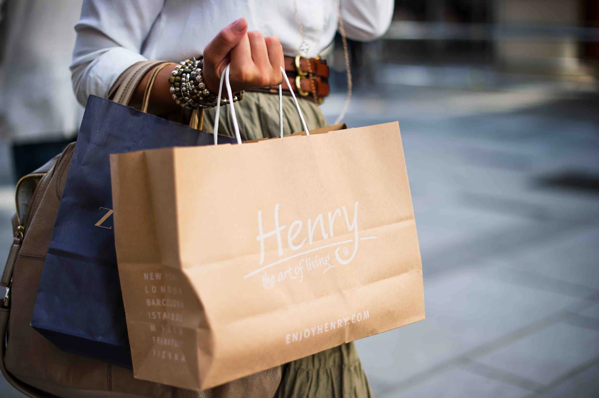 Customer carrying a kraft paper shopping bag