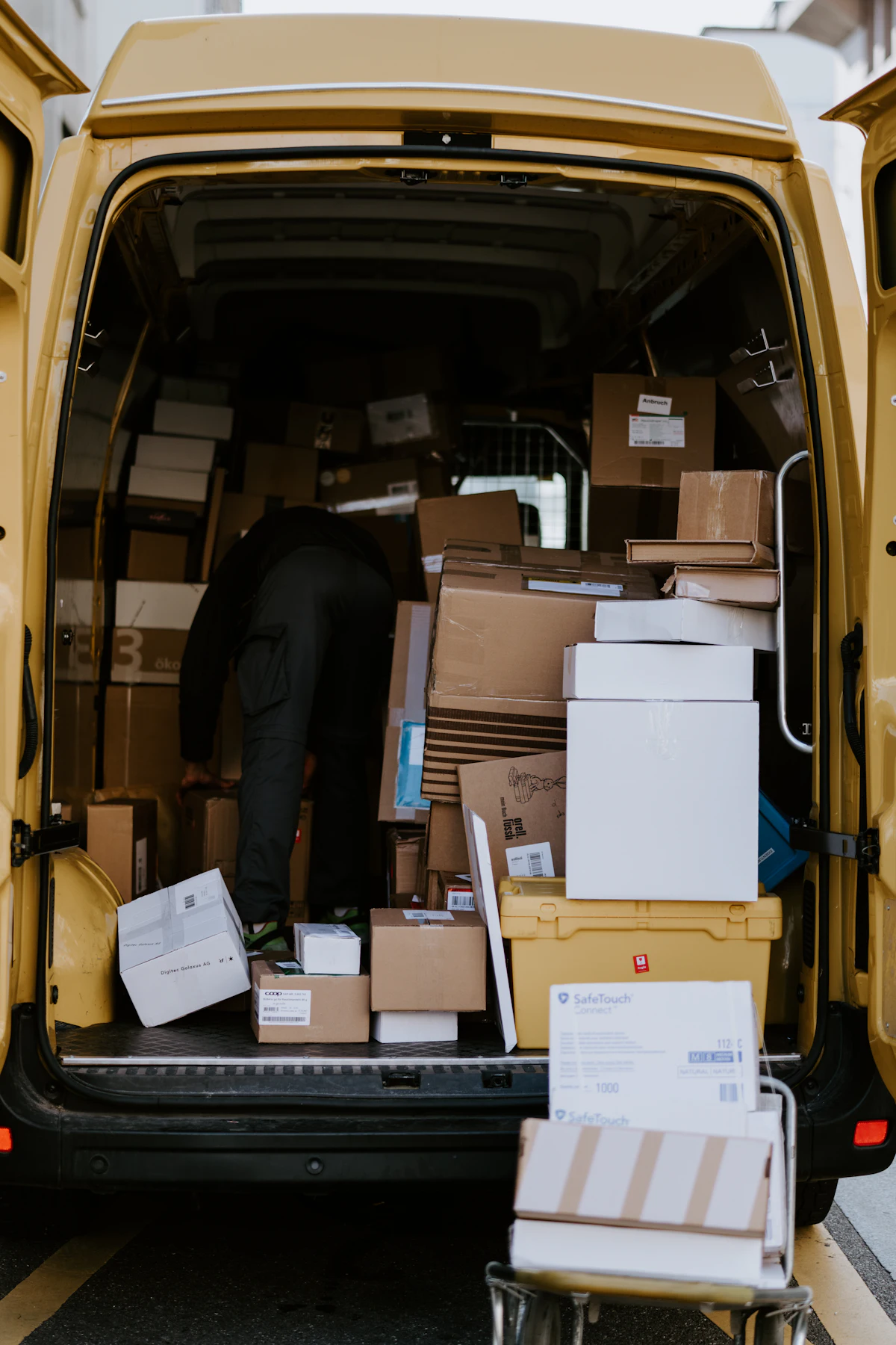 Cardboard boxes being loaded into a delivery van